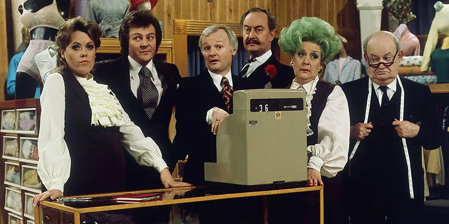 Are You Being Served?. Image shows left to right: Miss Shirley Brahms (Wendy Richard), Mr Dick Lucas (Trevor Bannister), Mr Wilberforce Humphries (John Inman), Captain Stephen Peacock (Frank Thornton), Mrs Betty Slocombe (Mollie Sugden), Mr Ernest Grainger (Arthur Brough). Credit: BBC