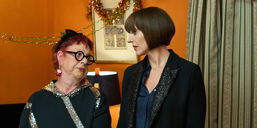 Christmas Carole. Image shows left to right: Ghost of Christmas Present (Jo Brand), Carole Mackay (Suranne Jones)