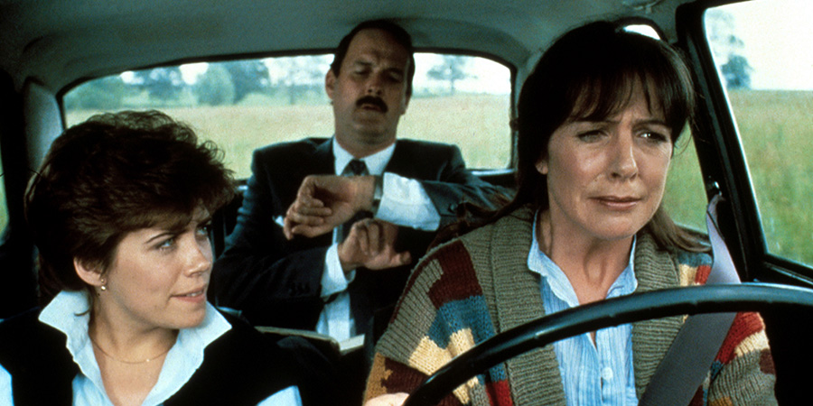 Clockwise. Image shows left to right: Laura Wisely (Sharon Maiden), Brian Stimpson (John Cleese), Pat (Penelope Wilton). Credit: STUDIOCANAL