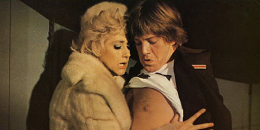 Confessions From A Holiday Camp. Image shows from L to R: Antonia Whitemonk (Liz Fraser), Timothy Lea (Robin Askwith)