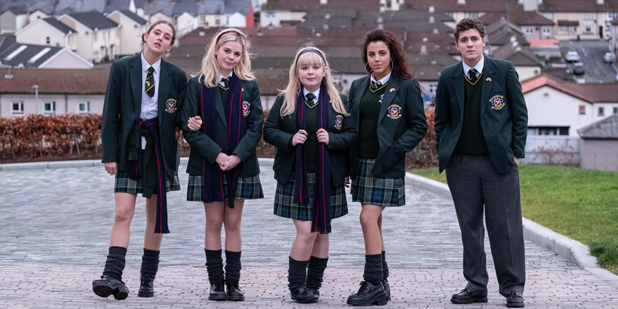 Derry Girls. Image shows from L to R: Orla McCool (Louisa Harland), Erin Quinn (Saoirse-Monica Jackson), Clare Devlin (Nicola Coughlan), Michelle Mallon (Jamie-Lee O'Donnell), James Maguire (Dylan Llewellyn). Copyright: Hat Trick Productions