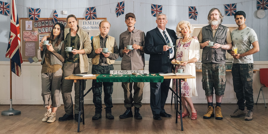 Detectorists. Image shows from L to R: Varde (Orion Ben), Louise (Laura Checkley), Lance Stater (Toby Jones), Andy Stone (Mackenzie Crook), Terry (Gerard Horan), Sheila (Sophie Thompson), Russell (Pearce Quigley), Hugh (Divian Ladwa)