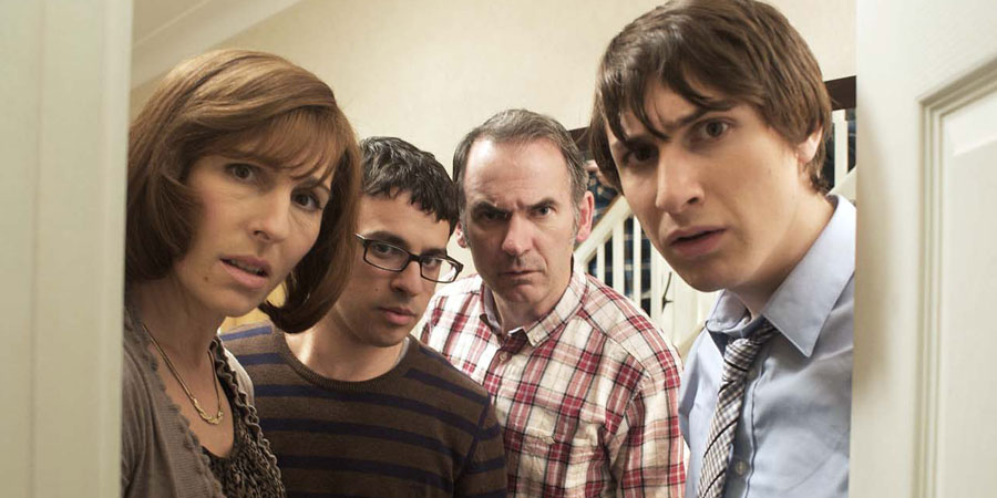 Friday Night Dinner. Image shows from L to R: Jackie (Tamsin Greig), Adam (Simon Bird), Martin (Paul Ritter), Jonny (Tom Rosenthal). Copyright: Popper Pictures / Big Talk Productions