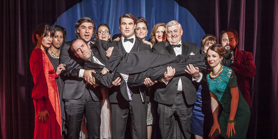 I Want My Wife Back. Image shows from L to R: Bex (Caroline Catz), Nareesha (Priyanga Burford), Julian Wolverton (James Lance), Emma (Susannah Fielding), Curtis (Stewart Wright), Tamzin (Kate Miles), Abby (Abigail Thaw), Don (Peter Wight), Paula (Jan Francis), Grant (Kenneth Collard), Murray (Ben Miller). Copyright: Busby Productions / Mainstreet Pictures
