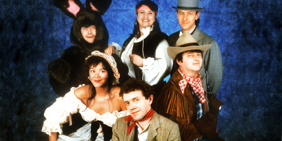 The Masterson Inheritance. Image shows from L to R: Phelim McDermott, Josie Lawrence, Jim Sweeney, Caroline Quentin, Lee Simpson, Paul Merton. Copyright: BBC