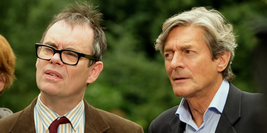 Murder On The Blackpool Express. Image shows from L to R: Kevin (Kevin Eldon), Doc (Nigel Havers)