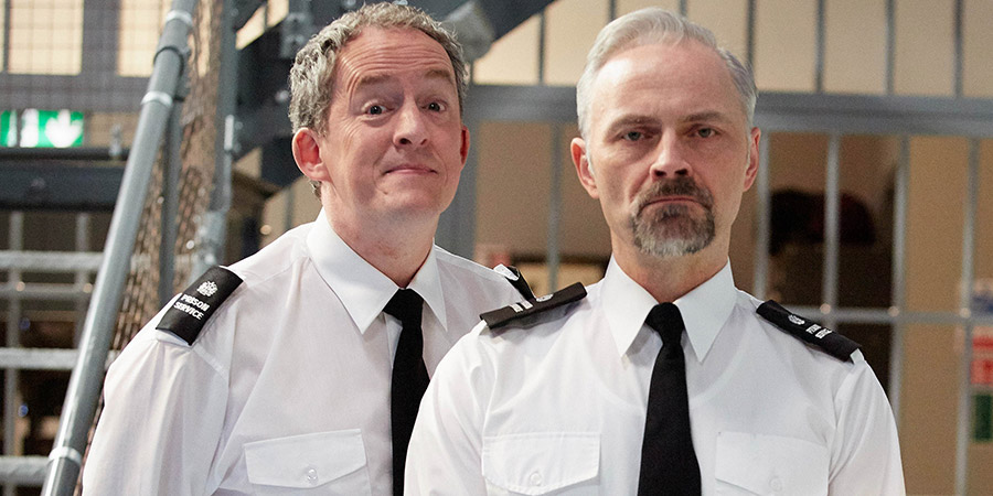 Porridge. Image shows from L to R: Officer Braithwaite (Dominic Coleman), Officer Meekie (Mark Bonnar). Copyright: BBC