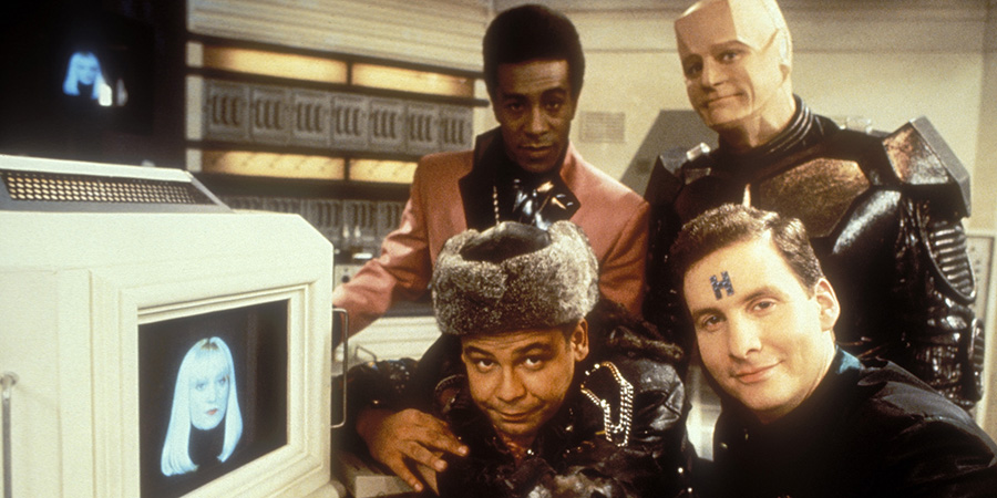 Red Dwarf. Image shows left to right: Holly (Hattie Hayridge), Lister (Craig Charles), Cat (Danny John-Jules), Rimmer (Chris Barrie), Kryten (Robert Llewellyn). Credit: BBC