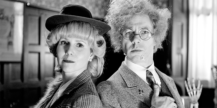 Reece Shearsmith In The Case Of The High Foot. Image shows from L to R: Hilda Stolf (Sally Phillips), Doctor (Reece Shearsmith). Copyright: Pett Productions