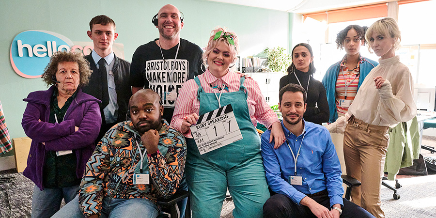 Ruby Speaking. Image shows left to right: Donna (Nicky Goldie), Craig (Dan Hiscox), Cameron (Jamal Franklin), Tom (Joe Sims), Ruby (Jayde Adams), Mark (Sam Swainsbury), Ellie (Amy-Leigh Hickman), Melons (Kiera Lester), Vicki (Katherine Kelly). Credit: Yellow Door Productions