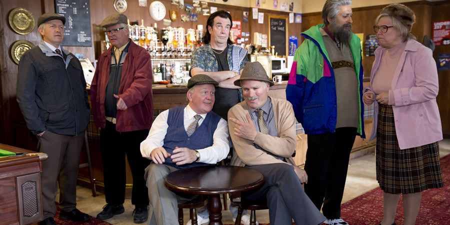 Still Game. Image shows from L to R: Tam Mullen (Mark Cox), Winston Ingram (Paul Riley), Jack Jarvis (Ford Kiernan), Boabby (Gavin Mitchell), Victor McDade (Greg Hemphill), Navid Harrid (Sanjeev Kohli), Isa Drennan (Jane McCarry)