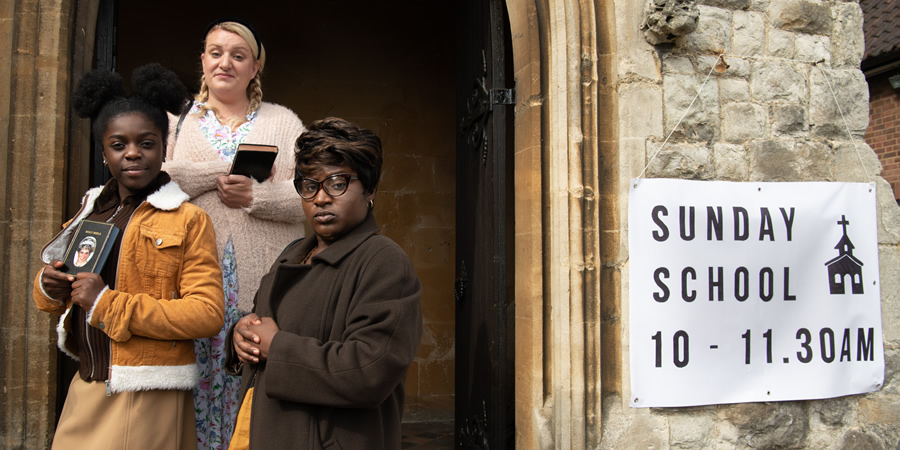 Susan Wokoma's Comedy Short. Image shows from L to R: Young Joannah (Whitney O'Nicholas), Sally (Daisy May Cooper), Ann (Susan Wokoma). Copyright: Roughcut Television