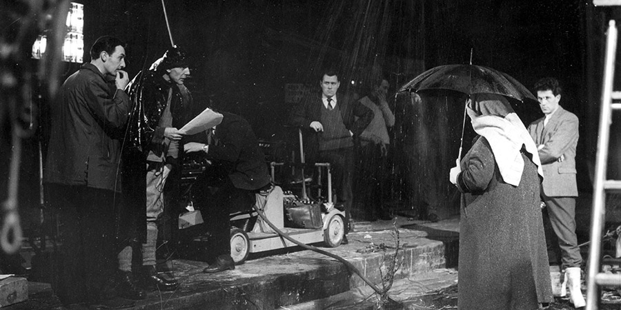 Sydney Lotterby (far left), Eric Sykes, Hattie Jacques (holding umbrella) and crew record a rainy scene