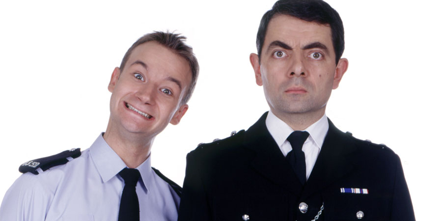 The Thin Blue Line. Image shows from L to R: P.C. Goody (James Dreyfus), Inspector Fowler (Rowan Atkinson). Copyright: Tiger Aspect Productions