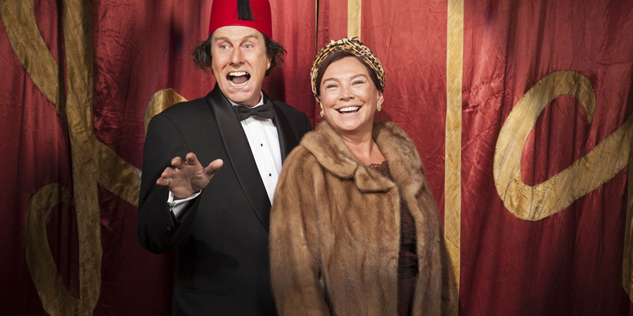 Tommy Cooper: Not Like That, Like This. Image shows from L to R: Tommy Cooper (David Threlfall), Dove Cooper (Amanda Redman). Copyright: Left Bank Pictures