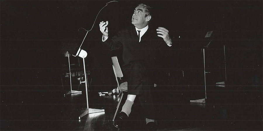 Tony Hancock seated on stage at the Royal Festival Hall. Photograph courtesy of THAS archive. Tony Hancock. Copyright: BBC