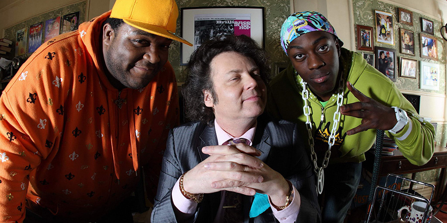 Trexx And Flipside. Image shows from L to R: Trexx (Peter Dalton), Mr Brilliance (Rich Fulcher), Flipside (David Ajala)
