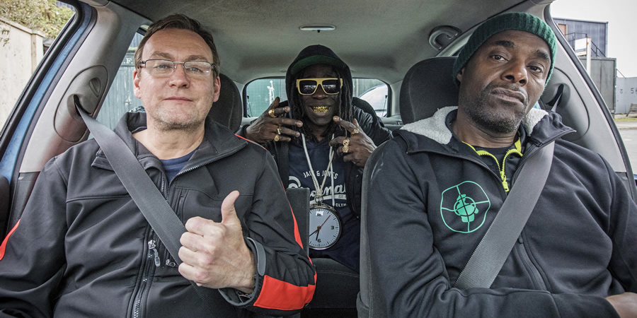 Urban Myths: Public Enemy (feat. Kev Wells). Image shows from L to R: Kev Wells (Philip Glenister), Flavor Flav (Abdul Salis), Chuck D (Paterson Joseph). Copyright: Happy Tramp Productions