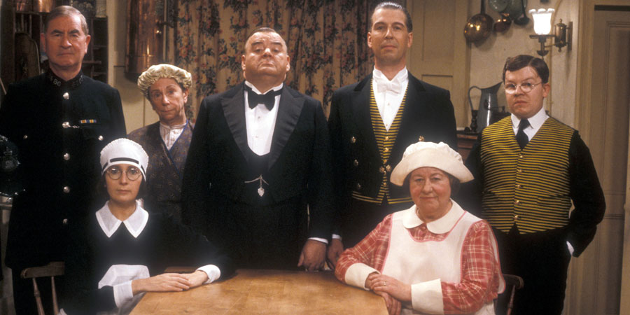 You Rang, M'Lord?. Image shows from L to R: P.C. Wilson (Bill Pertwee), Ivy Teasdale (Su Pollard), Mabel Wheeler (Barbara New), Alfred 'Alf' Stokes (Paul Shane), James Twelvetrees (Jeffrey Holland), Blanche Lipton (Brenda Cowling), Henry Livingstone (Perry Benson). Copyright: BBC