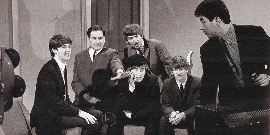 Bernie Winters watches television with The Beatles whilst Mike Winters adjusts the set. Credit: ABC Television