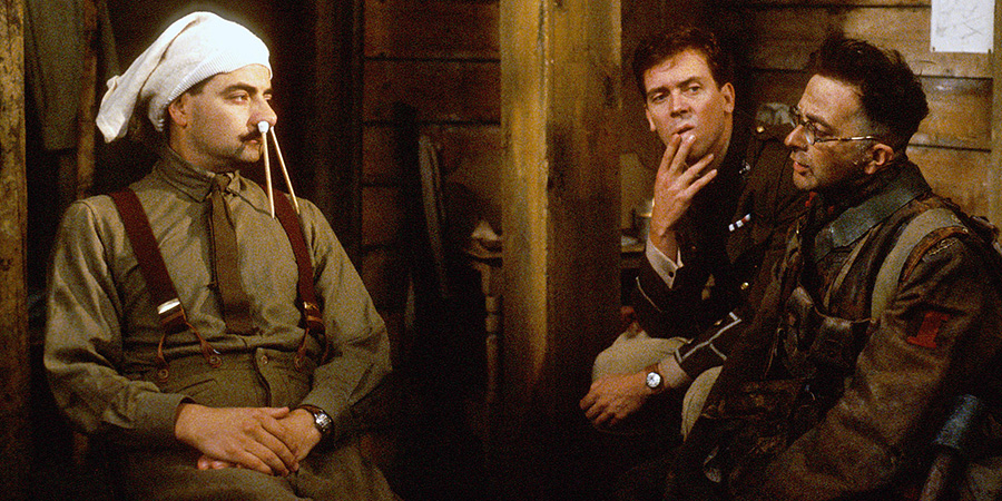 Blackadder. Image shows left to right: Captain Edmund Blackadder (Rowan Atkinson), Lieutenant George Barleigh (Hugh Laurie), Baldrick (Tony Robinson). Credit: BBC