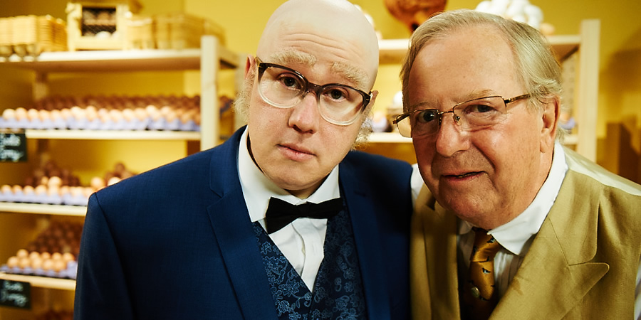 Bull. Image shows from L to R: Mr Richards (Matt Lucas), Egg Shop Owner (Tim Brooke-Taylor). Copyright: John Stanley Productions Bull. Image shows from L to R: Mr Richards (Matt Lucas), Egg Shop Owner (Tim Brooke-Taylor). Copyright: John Stanley Productions