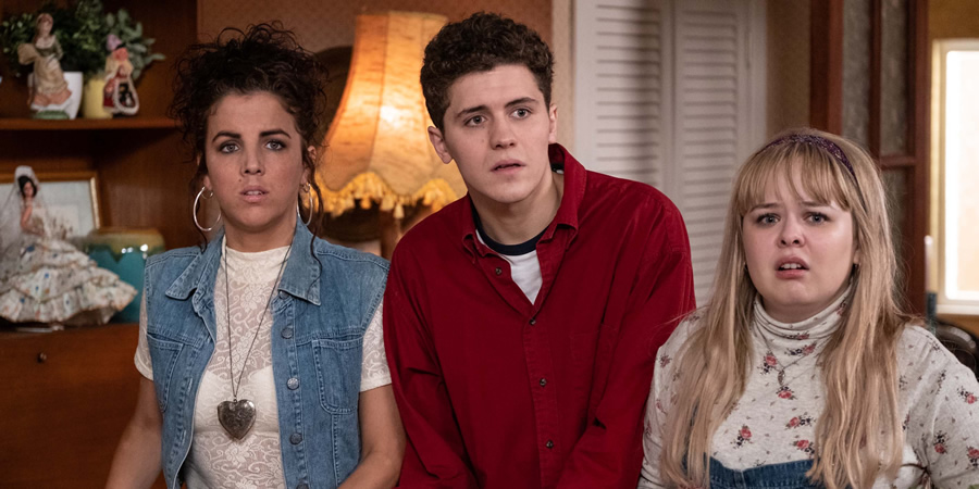 Derry Girls. Image shows from L to R: Michelle Mallon (Jamie-Lee O'Donnell), James Maguire (Dylan Llewellyn), Clare Devlin (Nicola Coughlan). Copyright: Hat Trick Productions