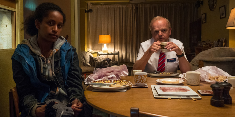 Don't Forget The Driver. Image shows from L to R: Rita (Luwam Teklizgi), Peter Green (Toby Jones)