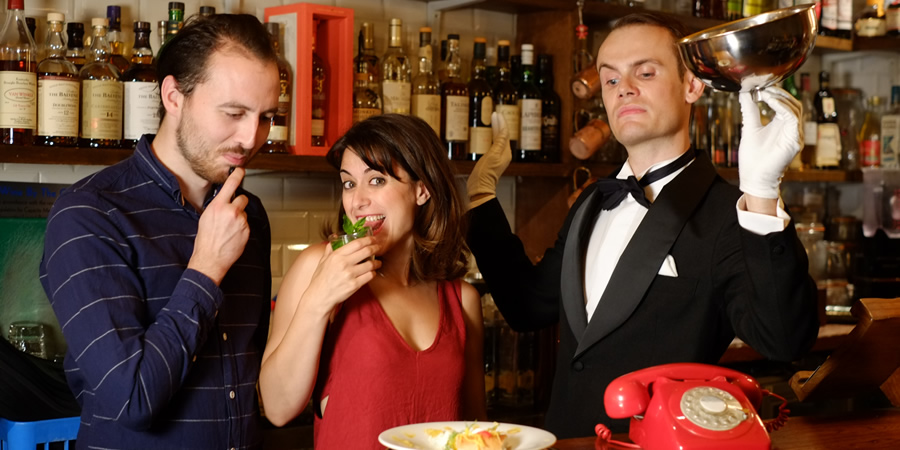 Foreigners. Image shows from L to R: Greg (Tommy Love), Josephine (Nathalie Codsi), Waiter (Stuart Walker)