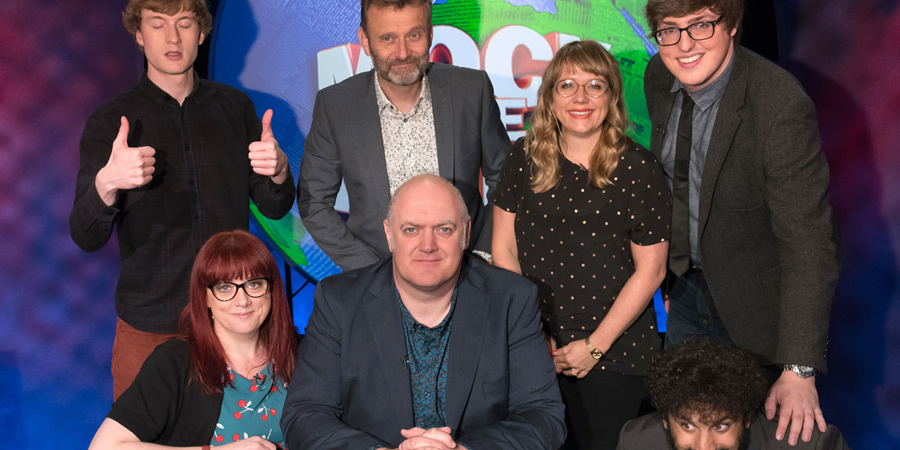 Mock The Week. Image shows from L to R: James Acaster, Angela Barnes, Hugh Dennis, Dara O Briain, Kerry Godliman, Glenn Moore, Nish Kumar. Copyright: Angst Productions