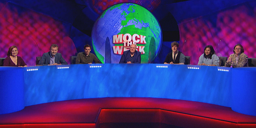 Mock The Week. Image shows from L to R: Laura Lexx, Hugh Dennis, Rhys James, Dara O Briain, Glenn Moore, Sukh Ojla, Ed Byrne. Copyright: Angst Productions