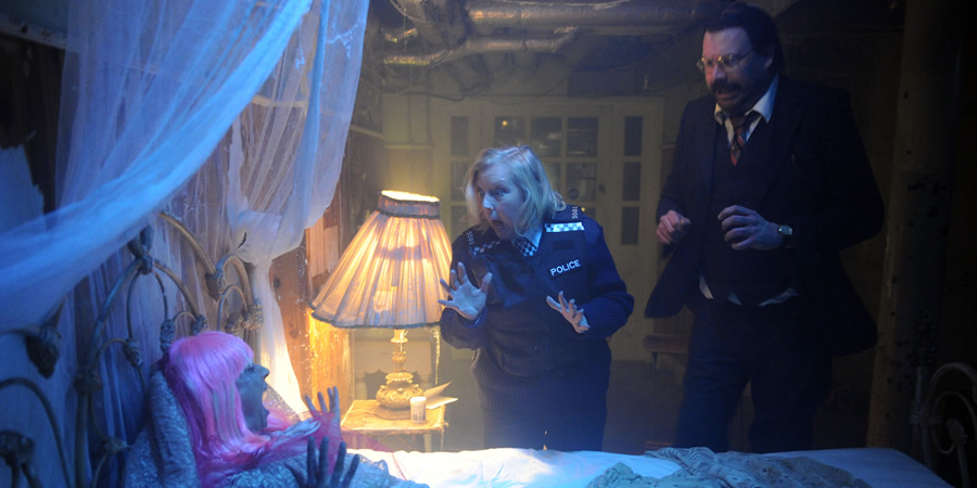 Murder In Successville. Image shows from L to R: Deborah Meaden, DI Sleet (Tom Davis). Copyright: Tiger Aspect Productions