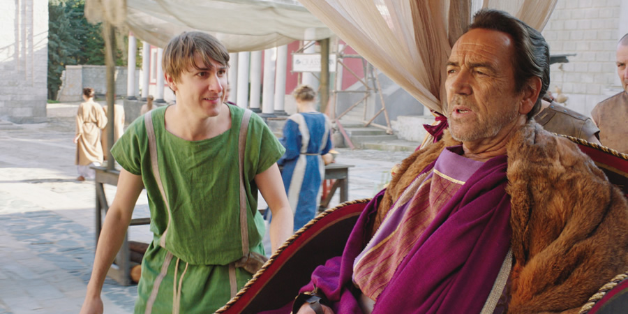 Plebs. Image shows from L to R: Marcus (Tom Rosenthal), Crassus (Robert Lindsay). Copyright: RISE Films