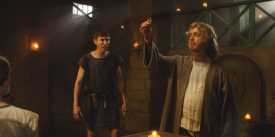 Plebs. Image shows from L to R: Marcus (Tom Rosenthal), Daedalus Greco (Tony Robinson). Copyright: RISE Films