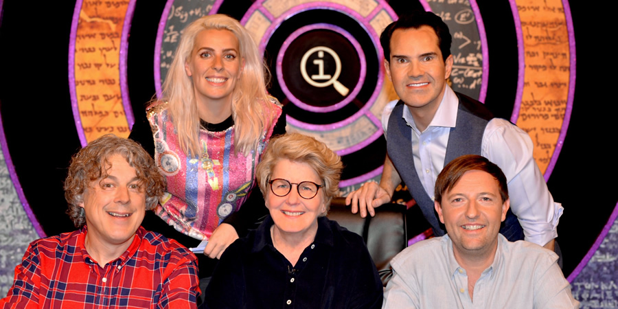 QI. Image shows from L to R: Alan Davies, Sara Pascoe, Sandi Toksvig, Jimmy Carr, Andrew Maxwell