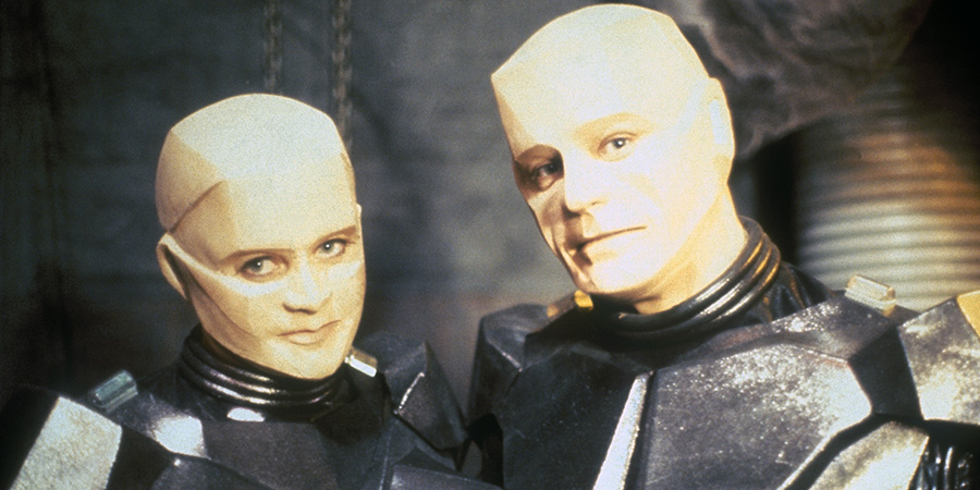 Red Dwarf. Image shows left to right: Mechanoid Camille (Judy Pascoe), Kryten (Robert Llewellyn)