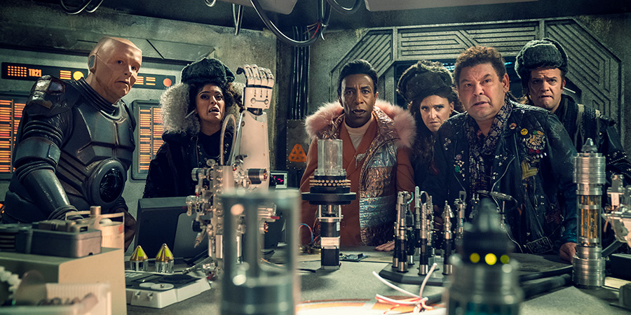 Red Dwarf. Image shows from L to R: Kryten (Robert Llewellyn), Sister Luna (Mandeep Dhillon), Cat (Danny John-Jules), Sister Peanut (Lucy Pearman), Lister (Craig Charles), Brother Sol (Tom Bennett)