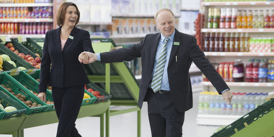 Trollied. Image shows from L to R: Cheryl (Sarah Parish), Gavin (Jason Watkins). Copyright: Roughcut Television