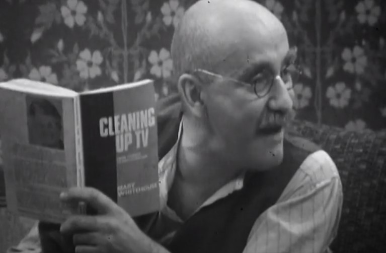 Alf Garnett reads Mary Whitehouse's book Cleaning Up TV. Alf Garnett (Warren Mitchell). Credit: BBC