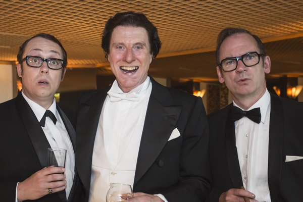 Tommy Cooper: Not Like That, Like This. Image shows from L to R: Eric Morecambe (Bob Golding), Tommy Cooper (David Threlfall), Eric Sykes (Paul Ritter). Copyright: Left Bank Pictures