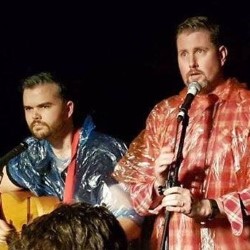 Emergency Poncho: Going In Dry. Image shows left to right: Dan Taylor, Gerard Lane