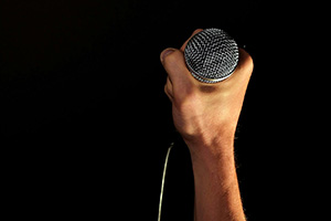 A hand holding a microphone