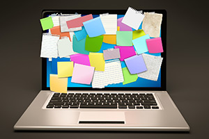 Laptop with post-it notes on it