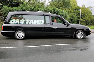 Hearse with the words Bastard. Taken by Final Journey funeral directors