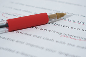 Red pen correcting a document