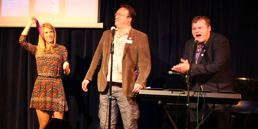 Rachel Parris receives the Bath Plug from award organisers Nick Steel (Bath Comedy Festival Director) and Jem Roberts (comedy historian and author). Image shows from L to R: Rachel Parris, Nick Steel, Jem Roberts