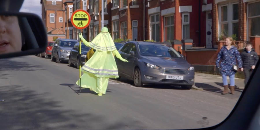 Lollypop lady wearing a florescent Burqa