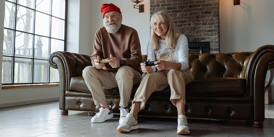 An elderly couple playing a video game