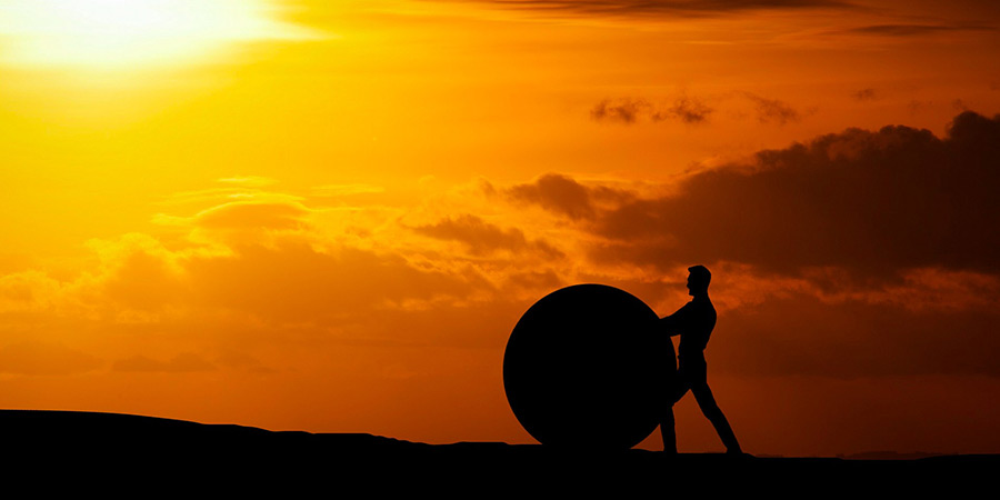 Generic picture of a man pushing a boulder