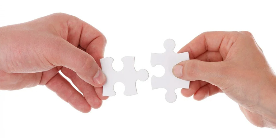 Generic picture of people holding jigsaw pieces